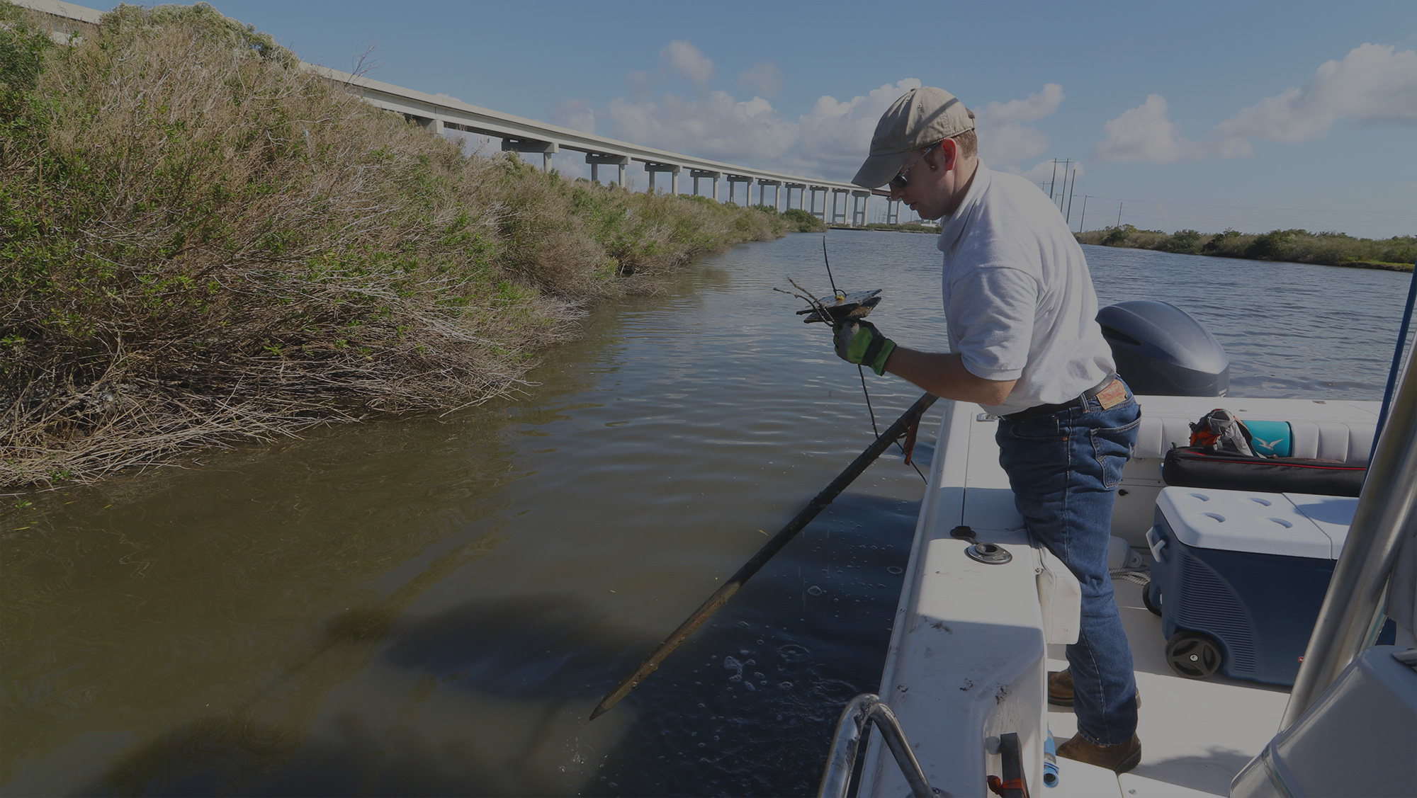 Man in a boat examining wetlands